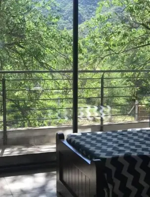 a room with a bed and a large window at Alquiler Temporal vacaciones in Villa Carlos Paz