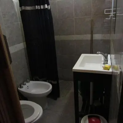 a bathroom with a sink and a toilet and a shower at CABAÑAS SANTA RITA - Tanti, Córdoba in Tanti