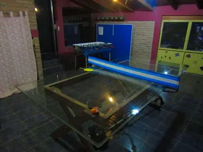 an empty pool in a room with a table at CABAÑAS SANTA RITA - Tanti, Córdoba in Tanti