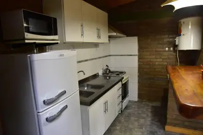 a kitchen with a white refrigerator and a sink at Atrapa Sueños I in Embalse