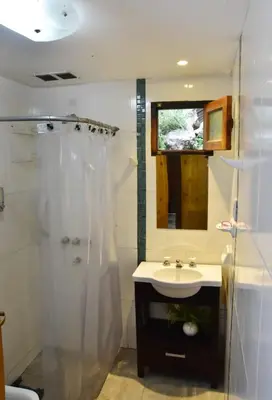 a bathroom with a shower and a sink and a mirror at Atrapa Sueños I in Embalse