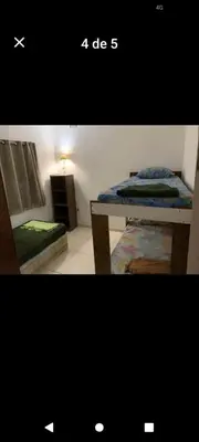 a picture of a bedroom with two beds and a table at Gerycasa in Cordoba