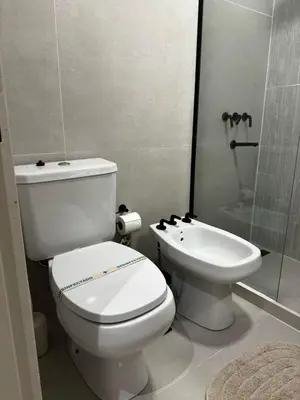 a bathroom with a white toilet and a sink at Cañada Premium- Imgo- Mostaza Sanchez in Cordoba