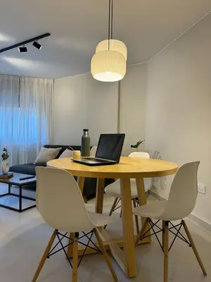 a dining room with a table with a laptop on it at Cañada Premium- Imgo- Mostaza Sanchez in Cordoba