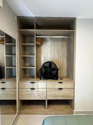 a closet with wooden shelves and a clock in it at Cañada Premium- Imgo- Mostaza Sanchez in Cordoba