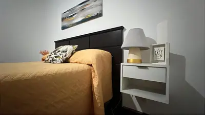 a bedroom with a bed and a nightstand with a lamp at CENTRO Departamento dos dormitorios in Cordoba