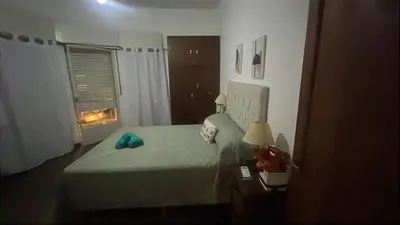 a bedroom with a green bed and a window at CENTRO Departamento dos dormitorios in Cordoba