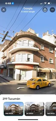 a yellow car parked in front of a building at CENTRO Departamento dos dormitorios in Cordoba