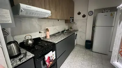 a small kitchen with a stove and a refrigerator at CENTRO Departamento dos dormitorios in Cordoba