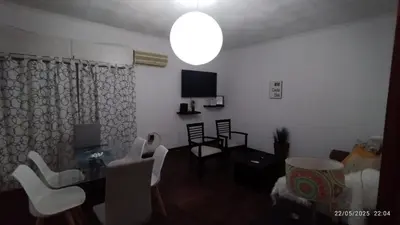 a living room with a table and chairs and a television at CENTRO Departamento dos dormitorios in Cordoba