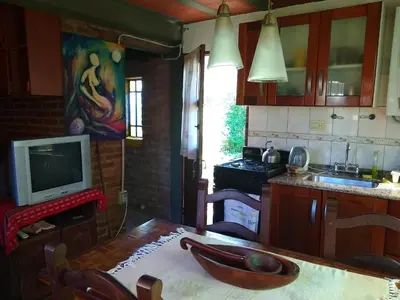 a kitchen with a wooden table with a bowl on it at Casita Loma Hermosa in Mina Clavero