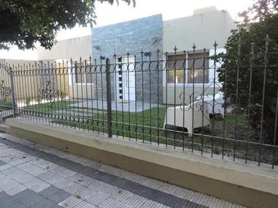 a wrought iron fence in front of a building at Algarrobo in Almafuerte
