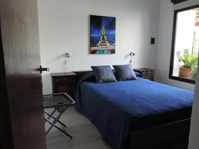 a bedroom with a bed with a blue comforter at Algarrobo in Almafuerte