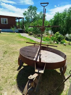 a wooden table sitting on top of a field at CABAÑAS La Perla in Bialet Massé