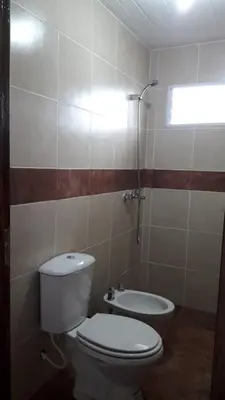 a small bathroom with a toilet and a sink at CABAÑAS La Perla in Bialet Massé