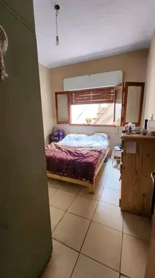 a small bedroom with a bed and a window at Departamento house in Río Cuarto