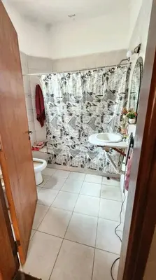 a bathroom with a toilet and a sink at Departamento house in Río Cuarto
