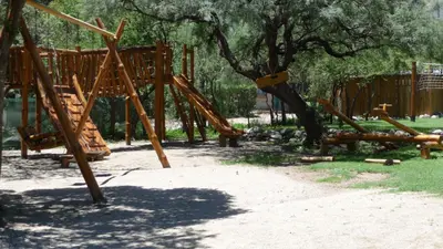 a playground in a park with a tree at Rincón de los Troncos in Merlo
