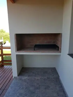 a fireplace on a deck with a brick fireplace at Alojamiento Premium en Las Marias De Cura Brochero in Villa Cura Brochero