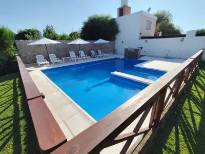 a swimming pool with a wooden fence around it at Alojamiento Premium en Las Marias De Cura Brochero in Villa Cura Brochero