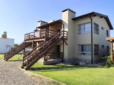 a house with a staircase on the side of it at Alojamiento Premium en Las Marias De Cura Brochero in Villa Cura Brochero
