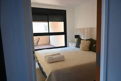 a small bedroom with a bed and a window at Unique & Cozy Apt in Cordobas heart in Cordoba