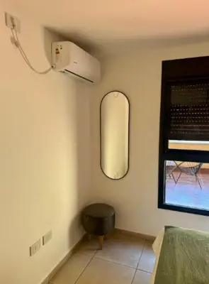 a room with a mirror and a stool and a window at Unique & Cozy Apt in Cordobas heart in Cordoba