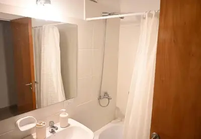 a bathroom with a sink and a shower curtain at Unique & Cozy Apt in Cordobas heart in Cordoba