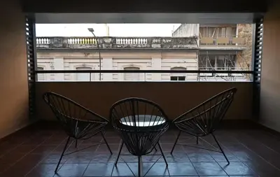 two chairs and a table in front of a window at Unique & Cozy Apt in Cordobas heart in Cordoba
