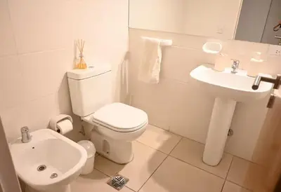 a white bathroom with a toilet and a sink at Unique & Cozy Apt in Cordobas heart in Cordoba
