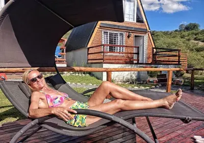 a woman in a bathing suit sitting in a chair at Alpinas Iguazu in Bialet Massé