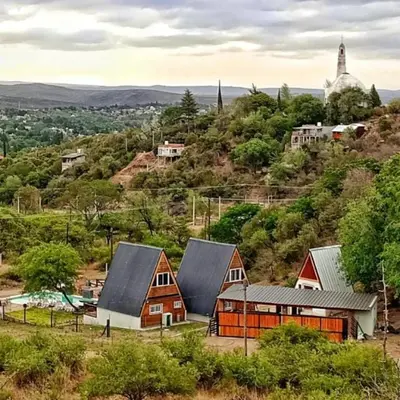 a group of houses on a hill with trees at Alpinas Iguazu in Bialet Massé
