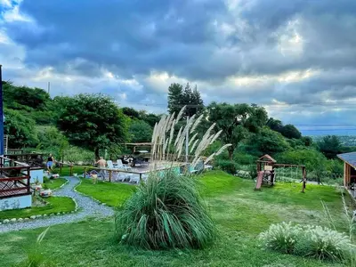 a garden with a fountain in the middle of a field at Alpinas Iguazu in Bialet Massé