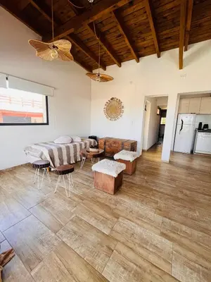 a living room with a couch and a table at La Serena Villa Rumipal - Cordoba in Villa Rumipal