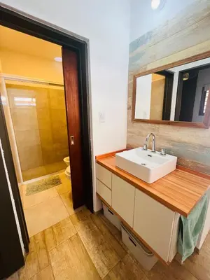 a bathroom with a sink and a mirror at La Serena Villa Rumipal - Cordoba in Villa Rumipal
