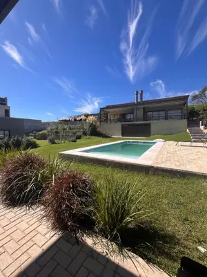 a house with a swimming pool in a yard at La Serena Villa Rumipal - Cordoba in Villa Rumipal