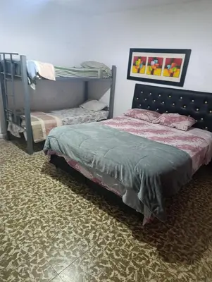 a bedroom with a bed and a bunk bed at Departamento azules in Cordoba