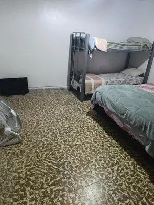 a room with two bunk beds and a carpet at Departamento azules in Cordoba