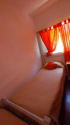 a small bedroom with a bed and a window at Gen Viajero Hostel in Merlo