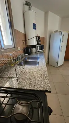 a kitchen with a white refrigerator and a counter top at Chacabuco Nueva Cordoba in Cordoba