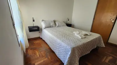 a teddy bear sitting on a bed in a bedroom at Chacabuco Nueva Cordoba in Cordoba