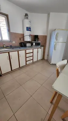 a kitchen with a refrigerator and a tile floor at Chacabuco Nueva Cordoba in Cordoba