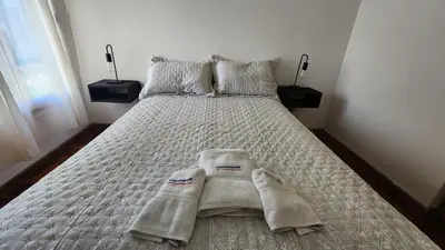 a bedroom with a bed with towels on it at Chacabuco Nueva Cordoba in Cordoba