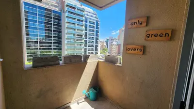 a room with two windows with the view of a city at Chacabuco Nueva Cordoba in Cordoba