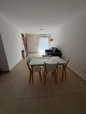 a living room with a table and a couch at Chacabuco Nueva Cordoba in Cordoba