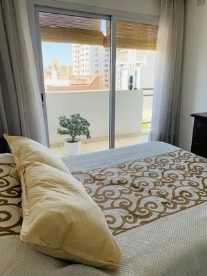 a bedroom with a bed with a large window at Depto Ángeles Fragueiro in Cordoba