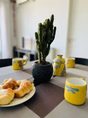 a table with a plate of croissants and a plant at Depto Ángeles Fragueiro in Cordoba