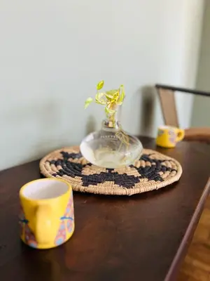 a table with a vase with a plant in it at Depto Ángeles Fragueiro in Cordoba