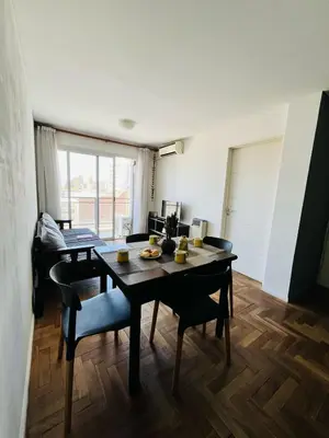 a dining room with a table and chairs in a room at Depto Ángeles Fragueiro in Cordoba
