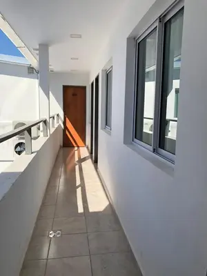 a hallway of a house with a door and windows at alojamiento bella vista in Villa Carlos Paz